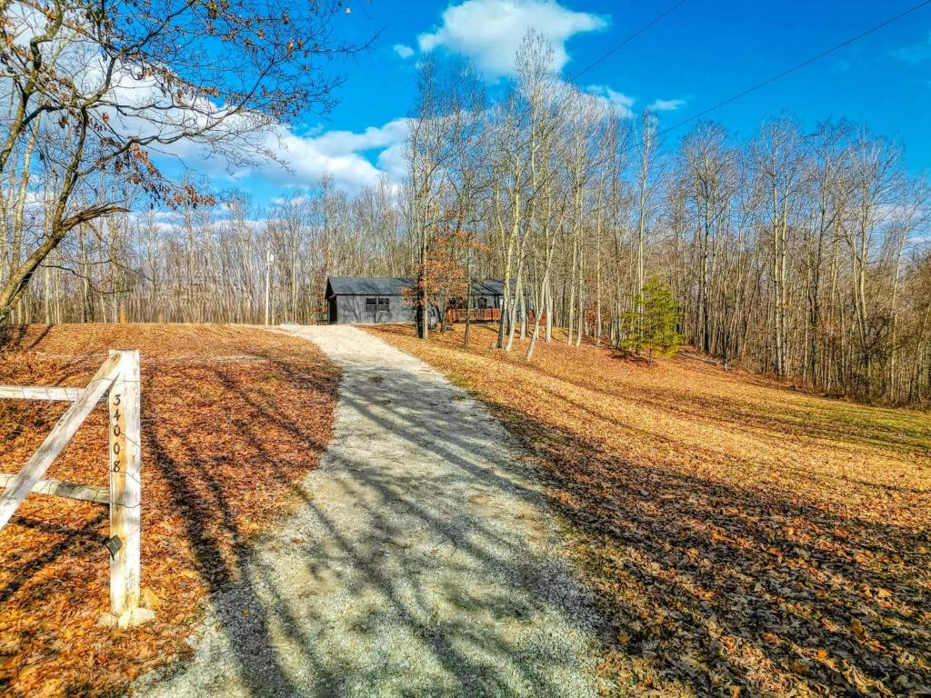 a dirt road leading to a barn in the woods at Buckingham Woods I Hocking Hills in Logan