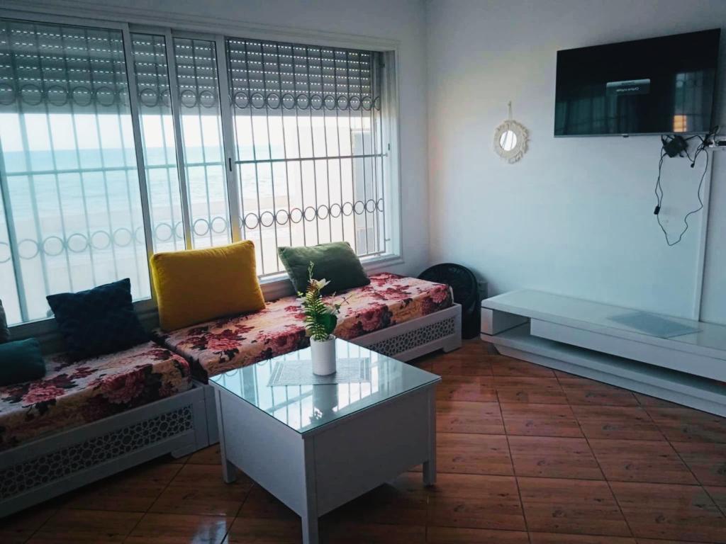 a living room with a couch and a table at Villa Sounine Rafraf in Bizerte