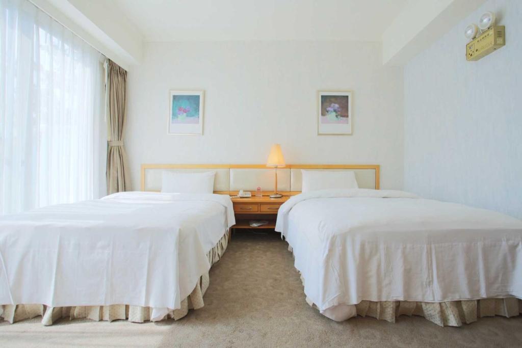 Postel nebo postele na pokoji v ubytování The Koos Hotel
