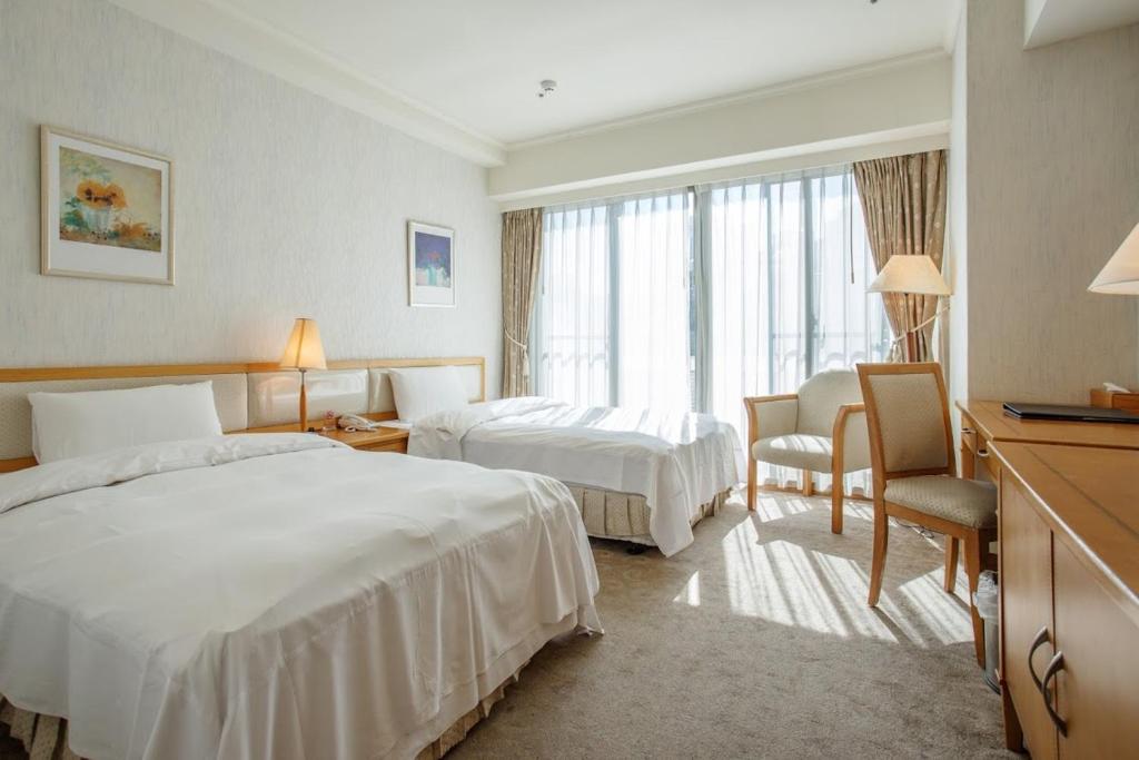Postel nebo postele na pokoji v ubytování The Koos Hotel