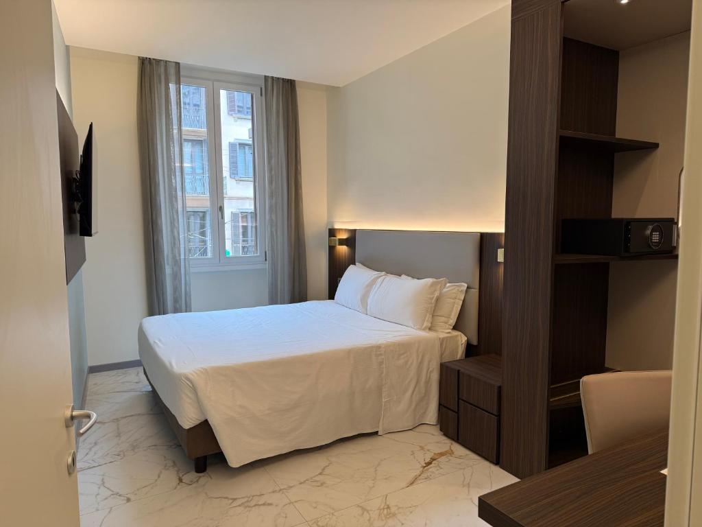 a hotel room with a bed and a window at Guest House Broletto in Milan