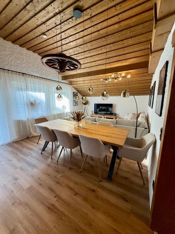 a dining room with a table and chairs and a couch at Bergheimat Stüble Allgäu in Bad Hindelang