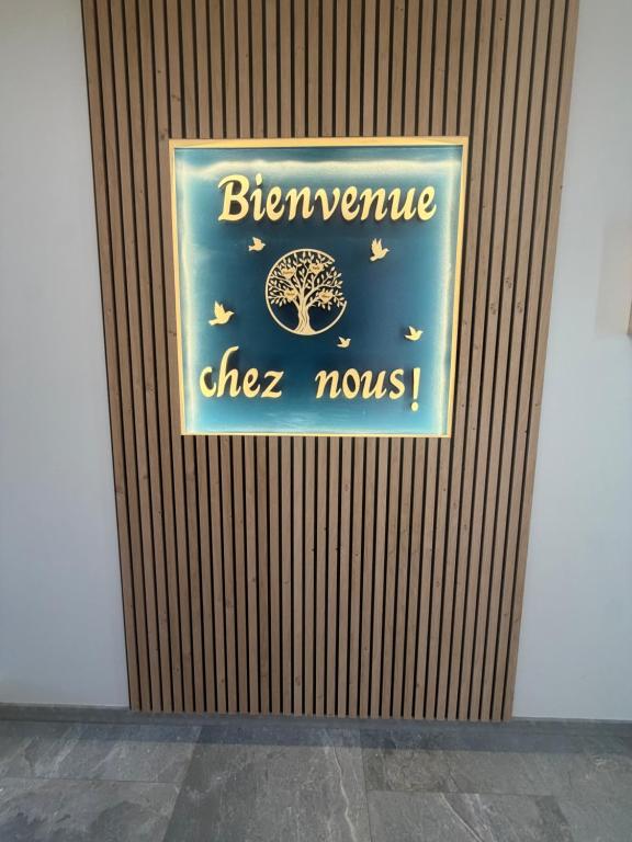 a sign on a wooden wall with a sign for a cheese movie at Le Cygne 2eme etage in Avranches