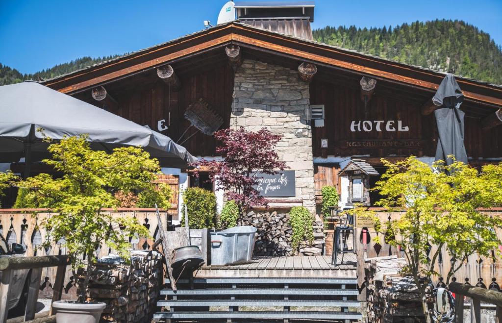 a building with stairs and trees in front of it at La Ferme in La Clusaz