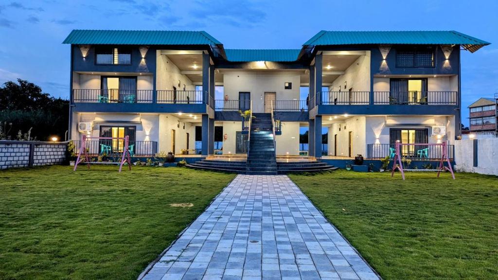 a large house with a pathway in front of it at Sylvara Resort in Sasan Gir