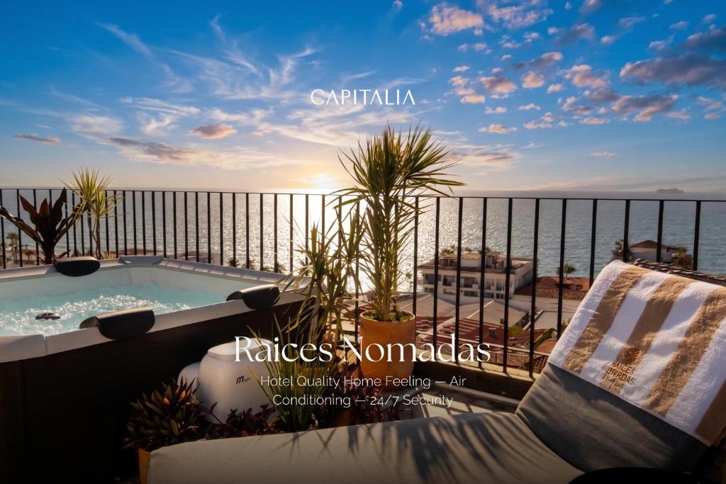 a hot tub on a balcony with the ocean at Raices Nomadas Boutique Hotel Vallarta in Puerto Vallarta