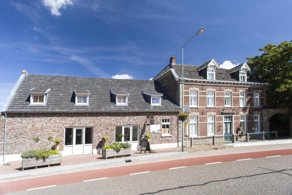 a large brick building on the side of a street at Vakantie Meerlo in Meerlo