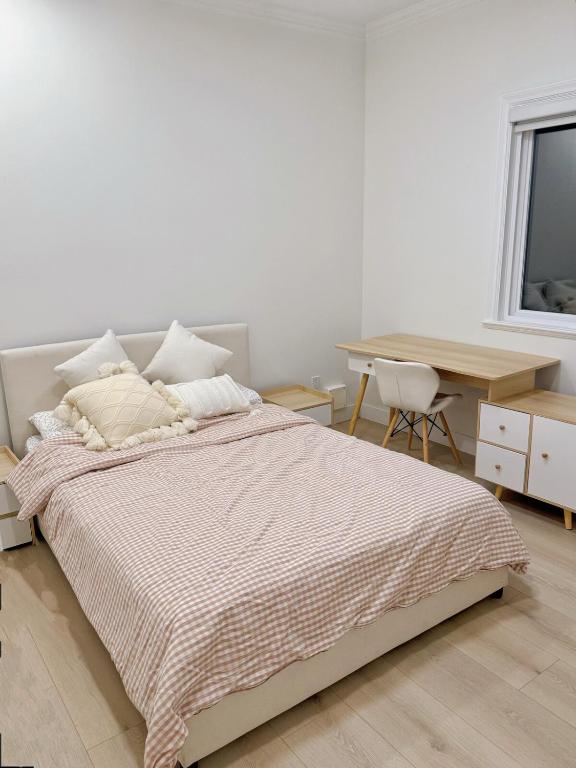 a bedroom with a bed and a desk and a table at Comfortable 1BR Retreat, Private Entry in Richmond