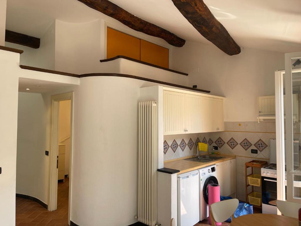 a kitchen with white cabinets and a stove at luca in Vernazza