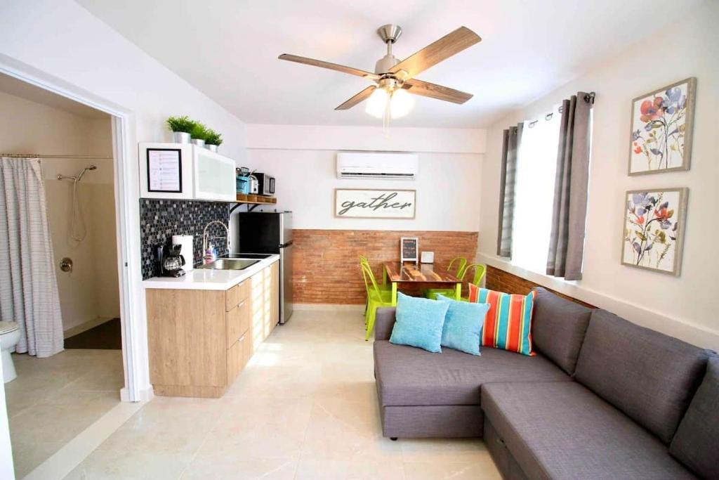 a living room with a couch and a kitchen at 1.1• Disabled • Generator • 1st Floor • Parking in Mayaguez