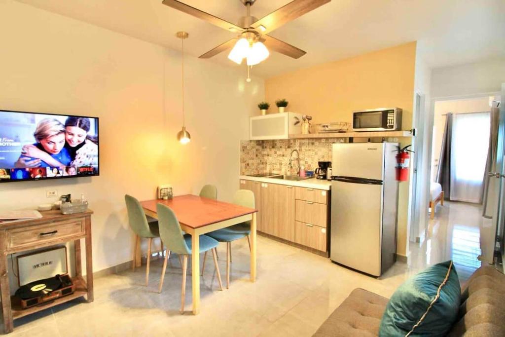 a kitchen and dining room with a table and a refrigerator at 1.7 • Balcony • Generator • Parking • 2nd Floor in Mayaguez