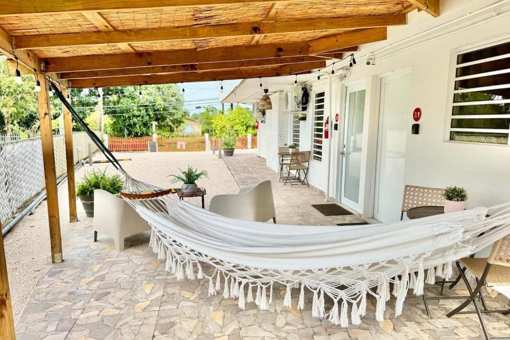 a hammock on the patio of a house at 3.1 Near Beach • Generator • Hammock • 1BR in Garita