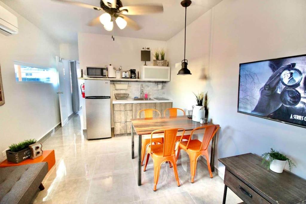 a kitchen and dining room with a table and chairs at 1.6 • Balcony • Generator • Parking • 2nd Floor in Mayaguez