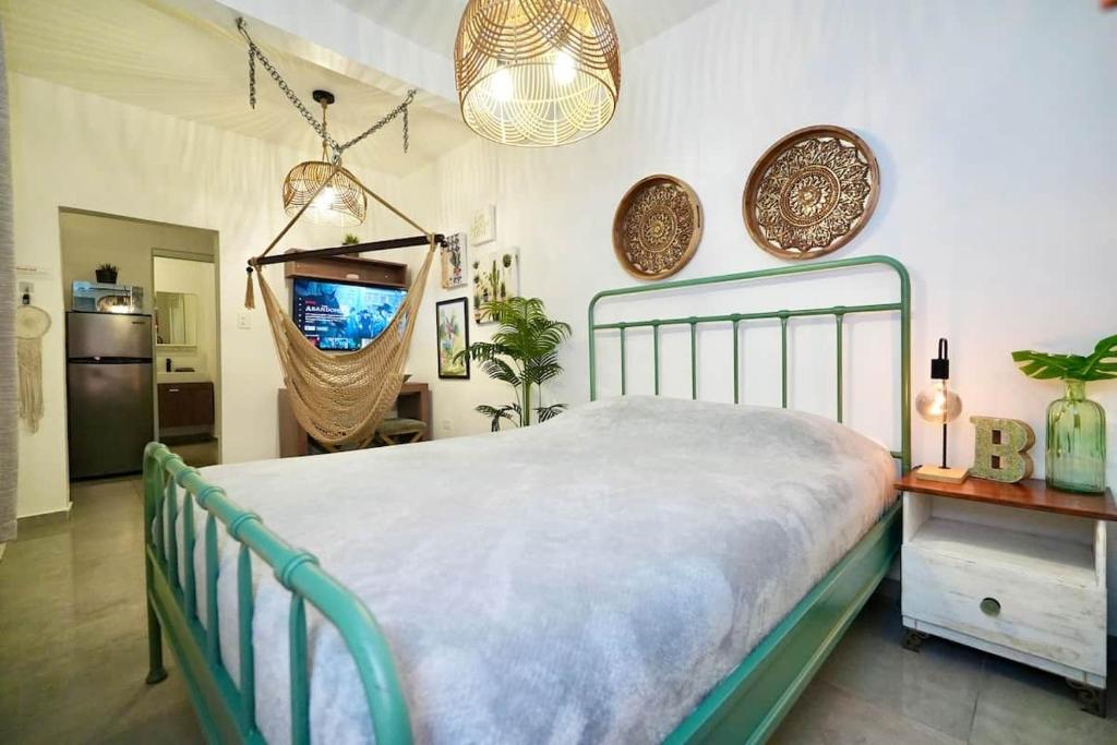 a bedroom with a bed and a tv in it at 1.4 • Generator • 1st Floor • Parking • 238sf in Mayaguez