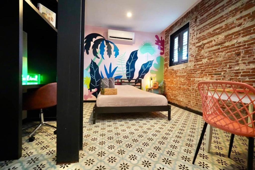 a room with a bed and a brick wall at 5.1 Loft • Lobby • Generator • Parking • 2nd Floor in Mayaguez