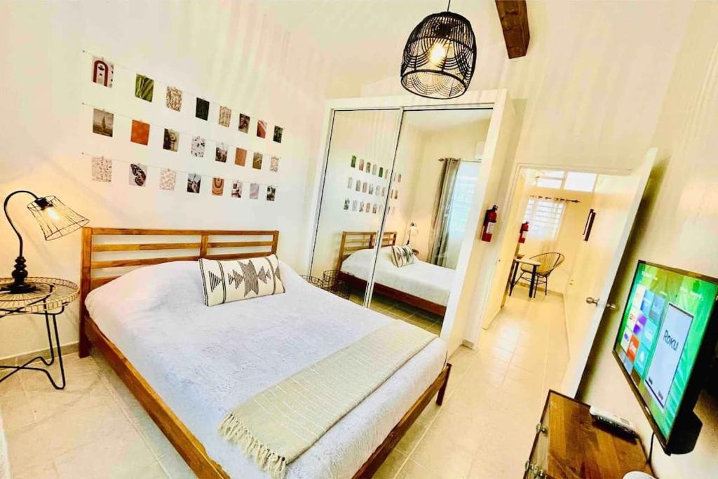 a bedroom with a bed and a mirror and a television at 3.6 Near Beach • Generator • Hammock • 2nd floor in Garita