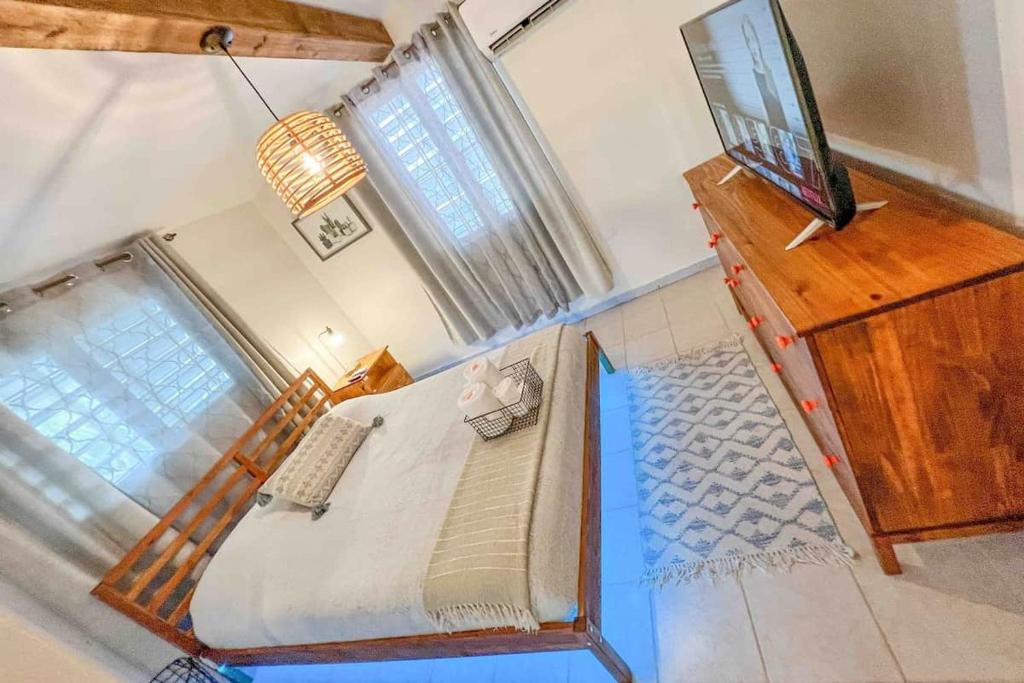 an overhead view of a bedroom with a bed and a television at 3.8 Near Beach • Generator • Hammock • 2nd floor in Garita
