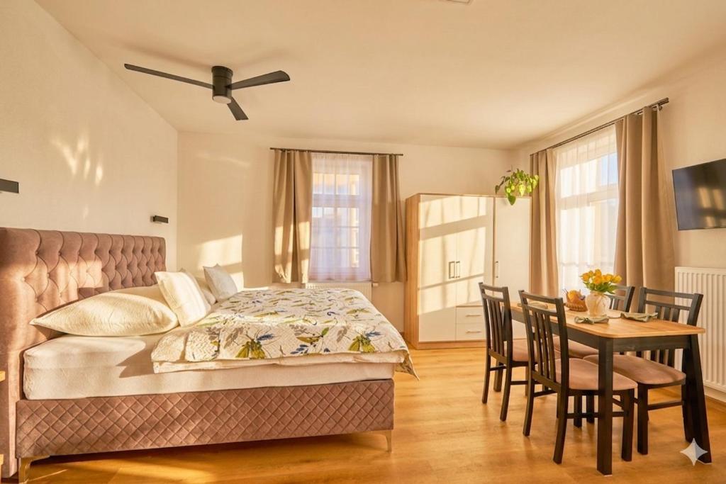 a bedroom with a bed and a table and chairs at Villa Harmony in Český Krumlov