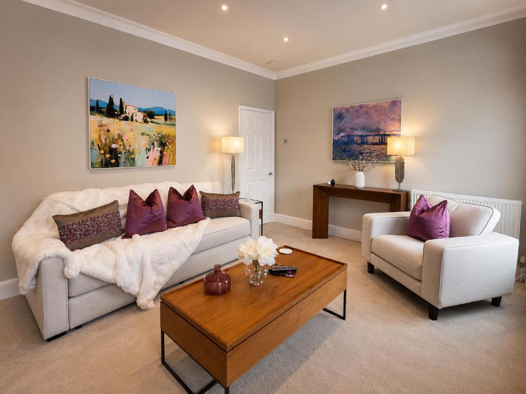 a living room with a couch and a coffee table at Lucy's Lodge- Most Stylish Apartment On Vibrant Bishy Road with Free Parking in York