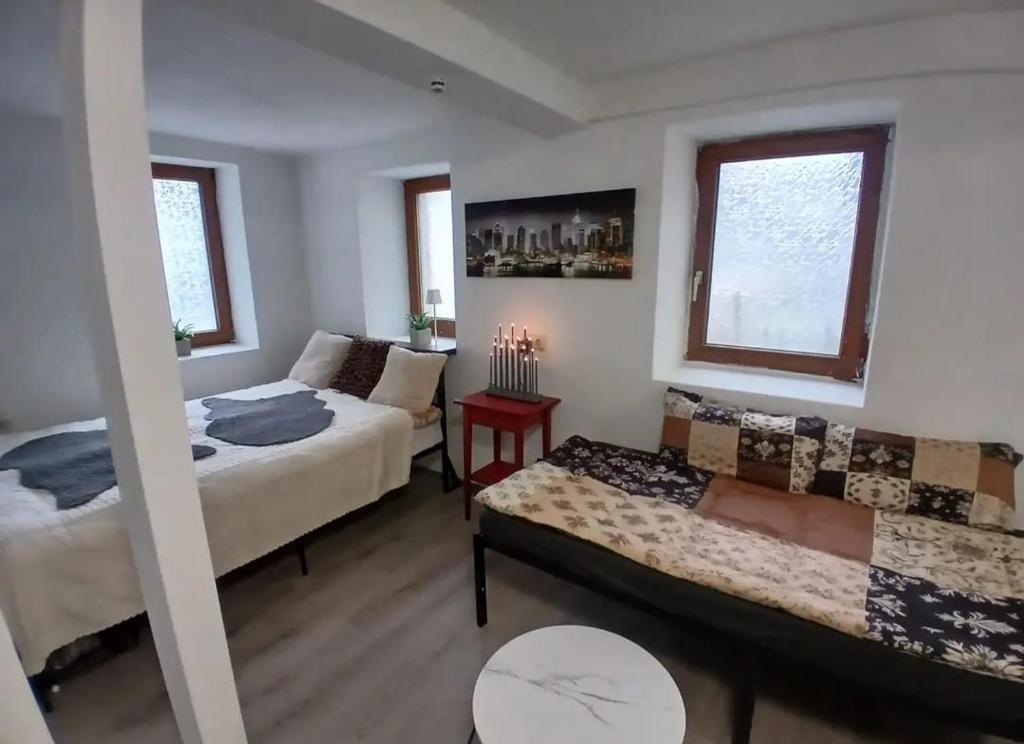 a living room with a bed and a couch at Apartment "Zum Rössel" Schönbrunn in Schönbrunn