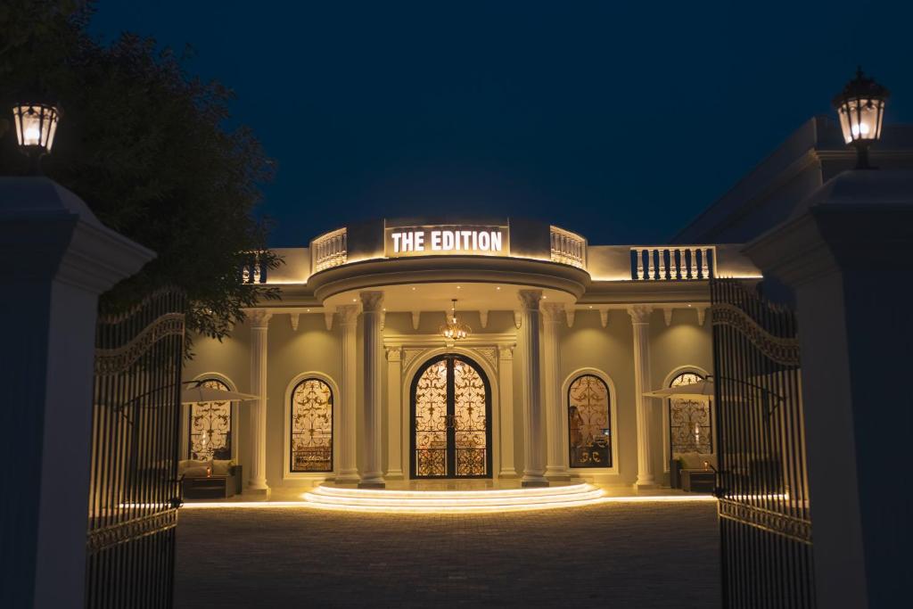 a building with a lit up entrance at night at The Edition Signature in Bahawalpur