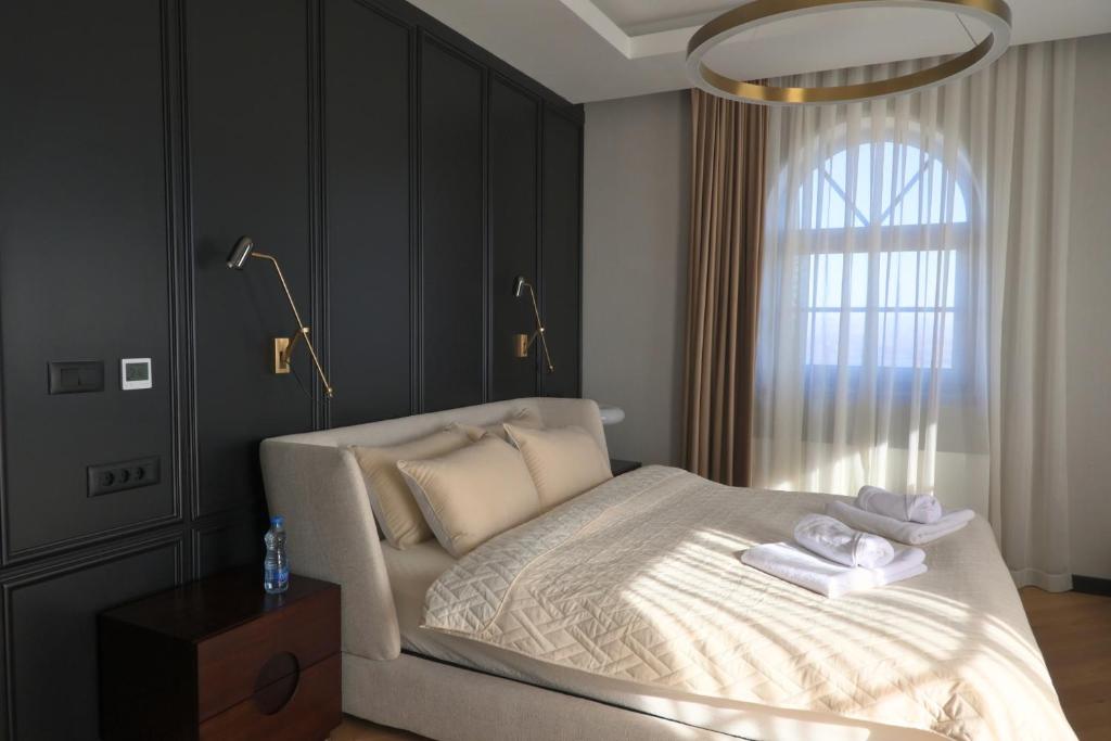 a bedroom with a bed with two towels on it at Djordjevic Estate Winery in Lapovo