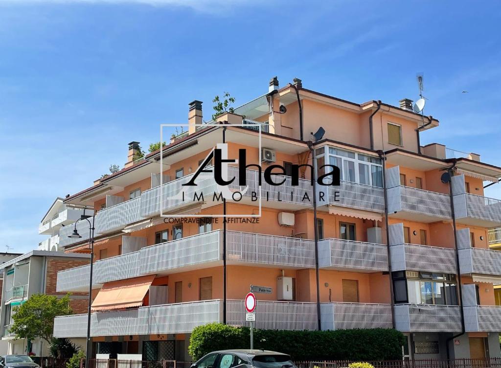 a building with a sign on the side of it at Sole in Grado
