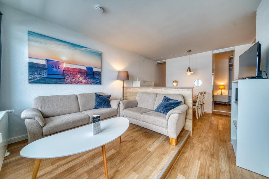a living room with two couches and a table at Ferienpark - Haus H, App 0H1107 - Apartment Baltic Panorama in Heiligenhafen