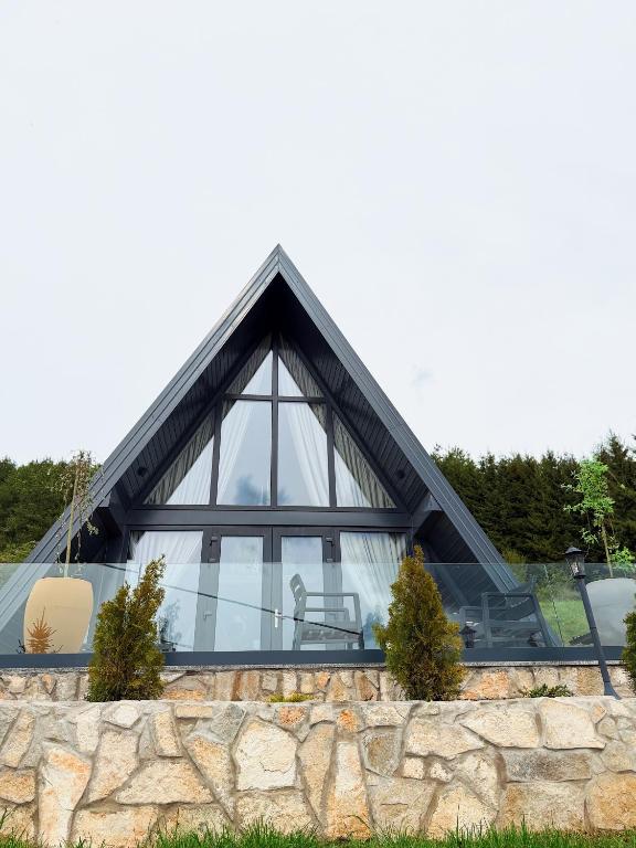 a glass house with a pointed roof at Casa Mia Resort in Kupres