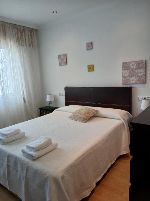a bedroom with a large bed with towels on it at Cecilia in Muros