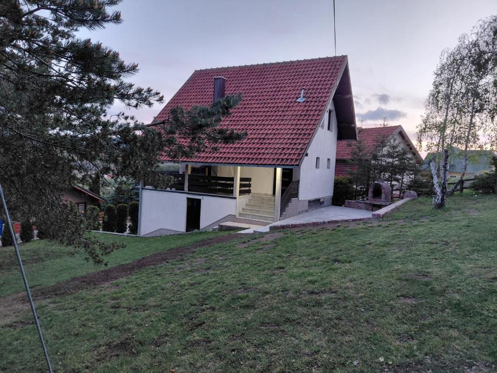 a white house with a red roof at Zlatibor Tornik View in Zlatibor
