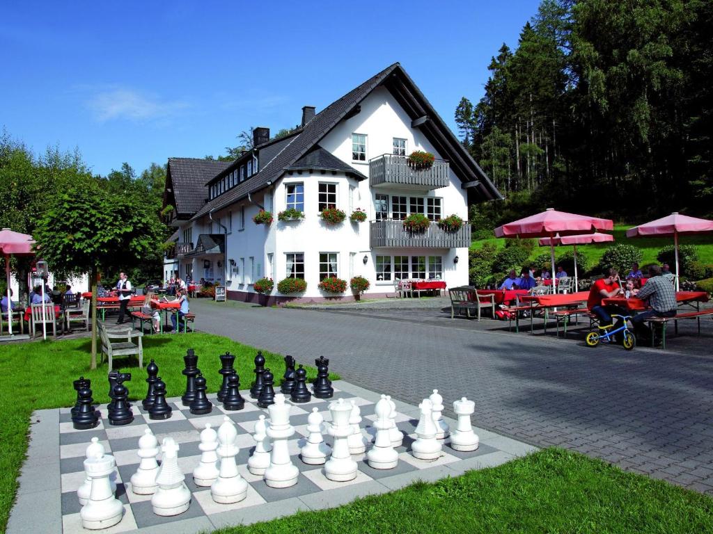a giant chessboard in front of a building at Gut Ahe Landgasthof Cafe Event in Kirchhundem