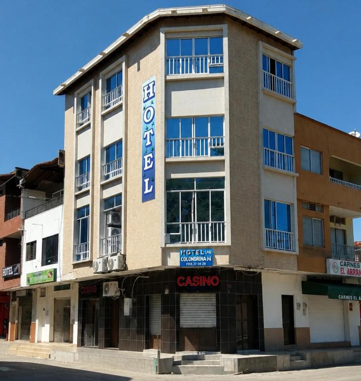 a building with a sign that reads caserolis at Hotel Las Golondrinas in Puerto Berrío
