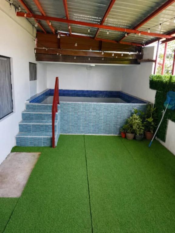 a room with a pool and green grass at Zoldyck Villa 1 in Bacolod
