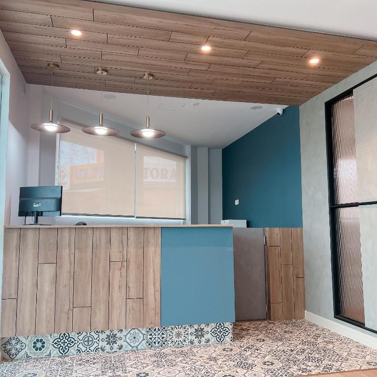 an empty room with a kitchen with blue walls at Hotel Double Star Klia in Sepang
