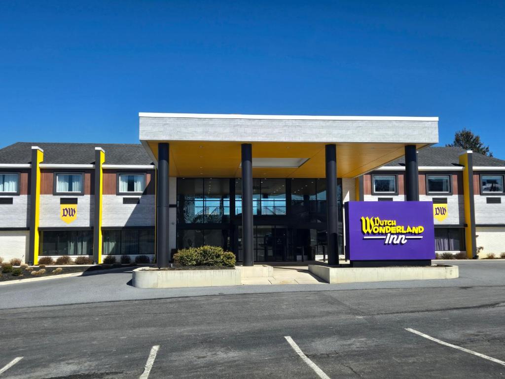 a building with a purple sign in a parking lot at Dutch Wonderland Inn in Lancaster