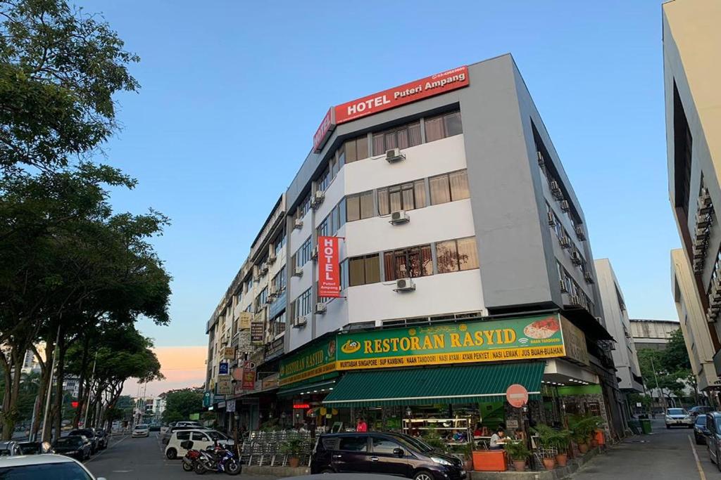 a building on a street with cars parked on the street at Puteri Ampang Hotel in Ampang