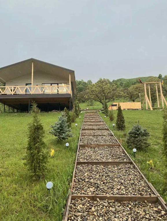 a set of train tracks in front of a building at vaav house in Tyudov