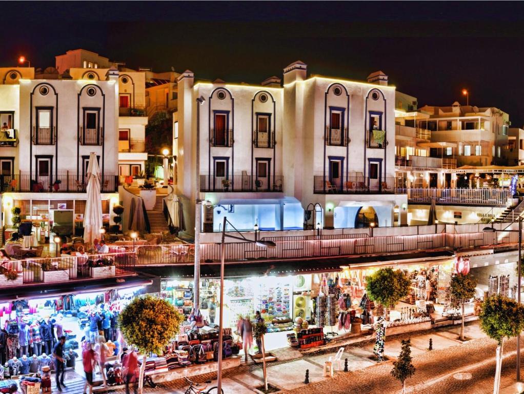 a group of buildings in a city at night at Quatro Life Hotel in Bodrum City