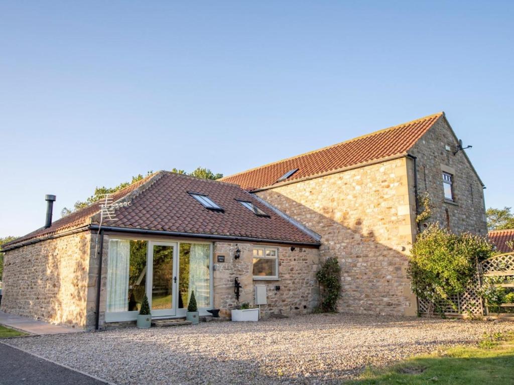 an old stone house with a large window at 1 Bed in Richmond oc-88588 in Easby