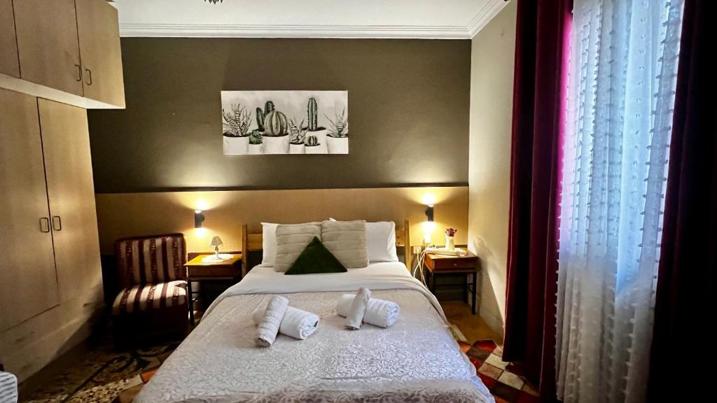 a bedroom with a bed with two pillows on it at Studio close to Train Station in Larisa