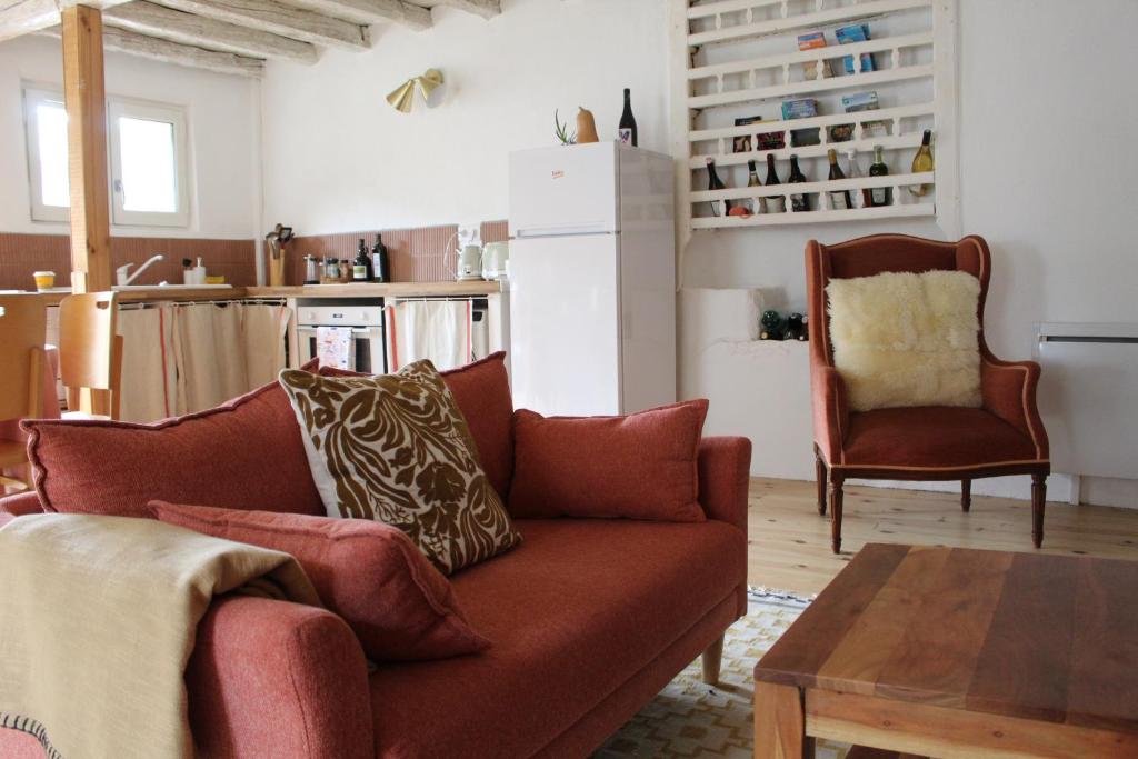 a living room with a couch and a table at La maison bleue des Pyrénées in Argut-Dessous