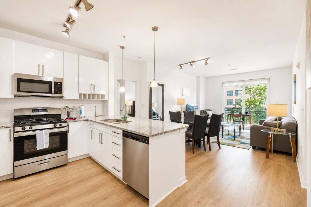 an open kitchen and living room with a dining room at Modern Apt Downtown with Pool in Stamford
