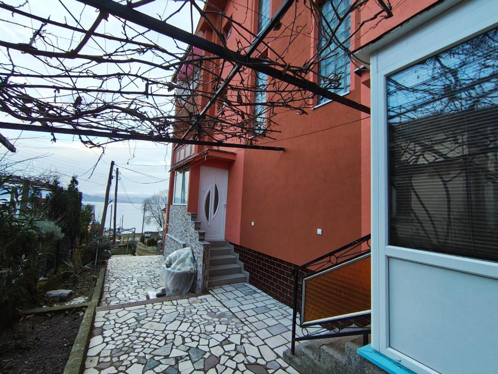 a red building with a stairway leading to a door at Villa Shine apartment 2 in Radožda