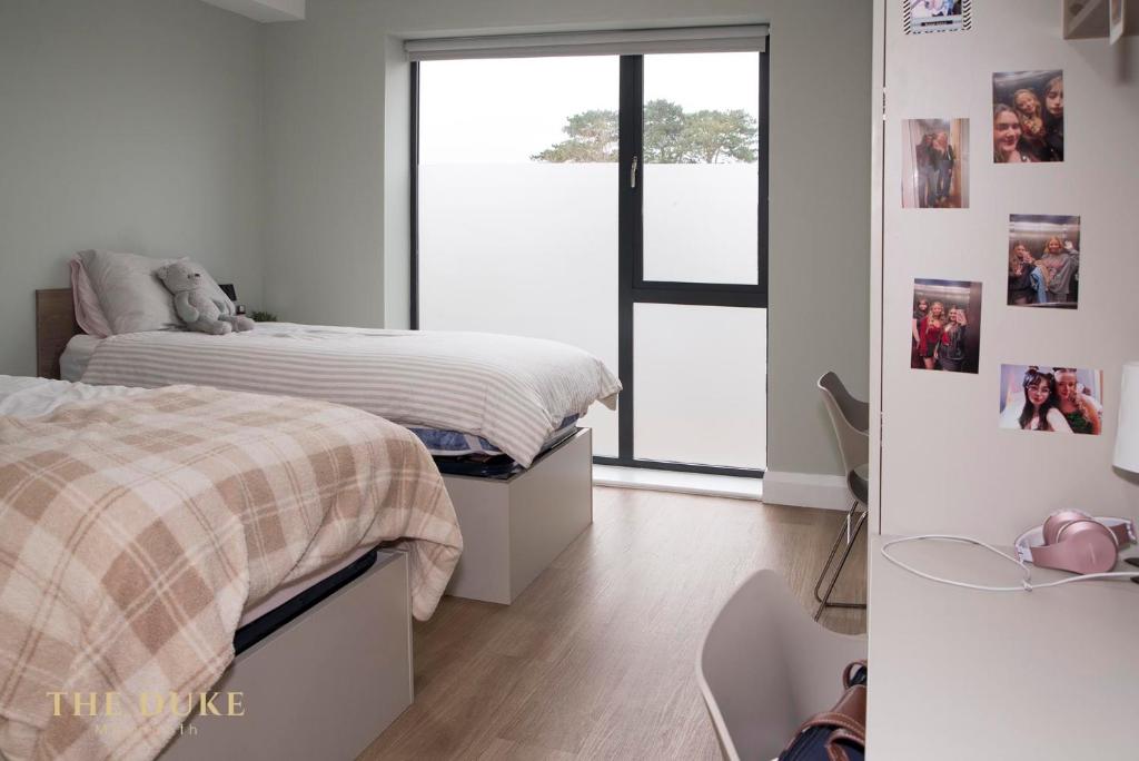 a bedroom with two beds and pictures on the wall at The Duke Maynooth in Maynooth