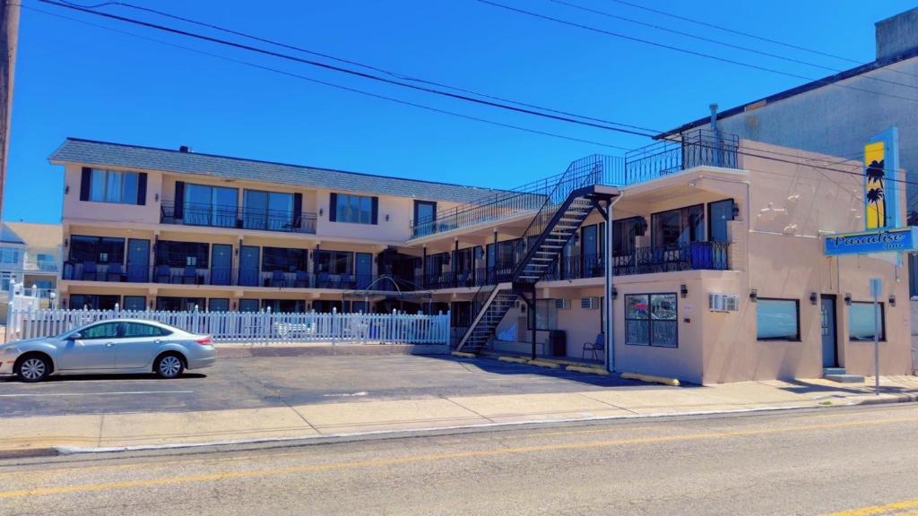 a car parked in a parking lot in front of a building at Paradise Inn in Wildwood