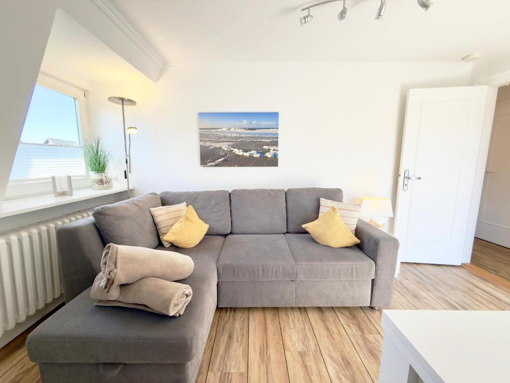 a living room with a couch and a table at Westerheide 51, App 2 in Wenningstedt