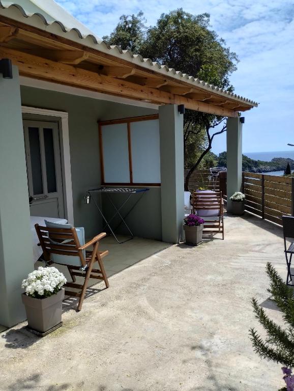 a patio with rocking chairs and aestead at Manganas Studios in Paleokastritsa