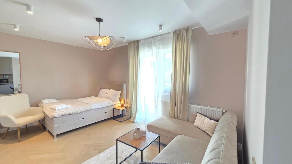 a living room with a couch and a bed at Your home away from home 3 in Floreşti
