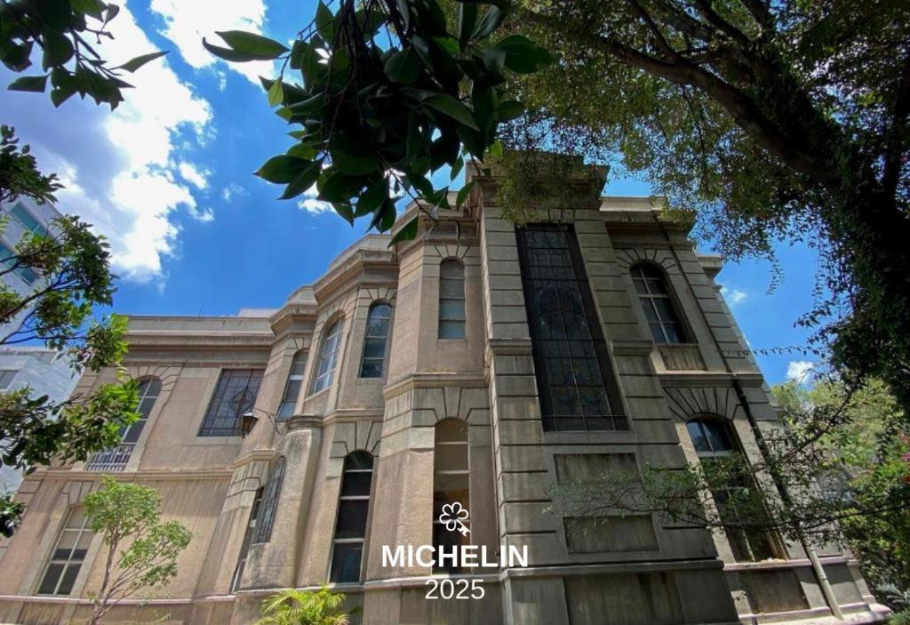 a building with a sign on the front of it at Maison Celeste in Mexico City